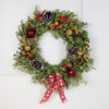 Whether hung from a door or displayed on a wall, this wreath brings holiday cheer to any space. Hand-decorated with pinecones, apples, and other seasonal accents, it's a delightful way to showcase Christmas spirit.