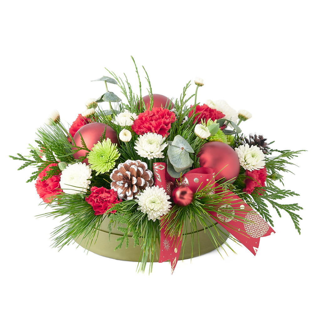 With festive red, green, and white tones and subtle decorative additions, this floral gift is guaranteed to add holiday cheer to any space. New York Blooms