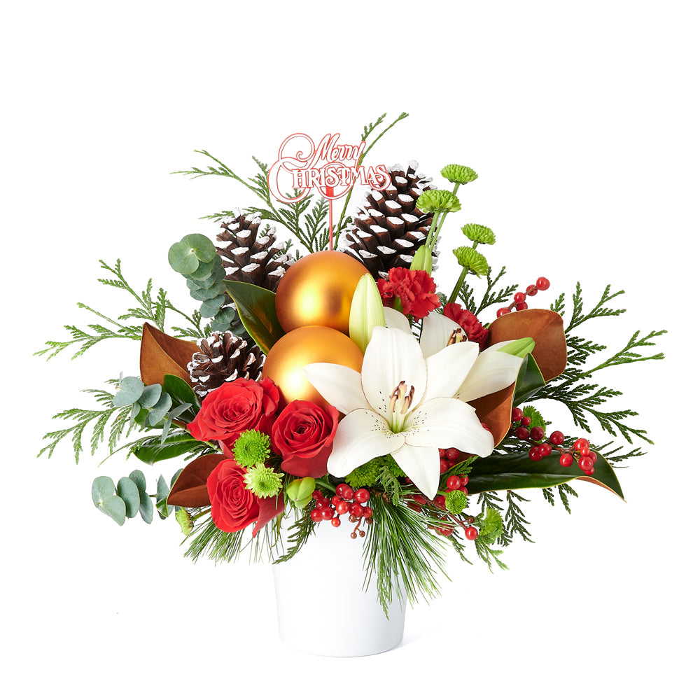 Celebrate the season with something merry and bright! The Joyous Christmas Floral Arrangement is the perfect gift to delight your loved ones.